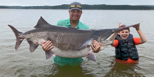 Oklahoma dad Cory Watters and his 9-year-old son Stetson reeled in a world-record 151.9-pound paddlefish Thursday morning on Keystone Lake.