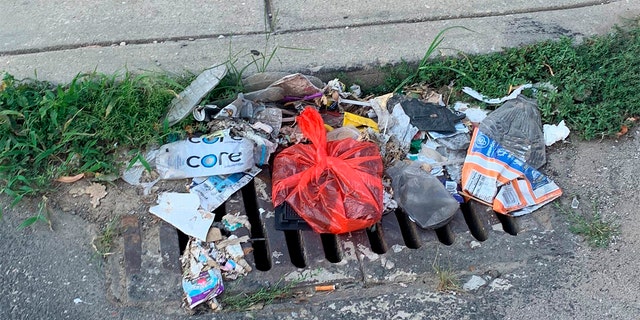 Trash rests on a street Tuesday, July 28, 2020, in Philadelphia. The COVID-19 pandemic has frustrated efforts to keep Philadelphia's streets clear of garbage this summer. (Kara Kneidl via AP)