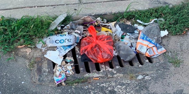 Trash rests on a street Tuesday, July 28, 2020, in Philadelphia. The COVID-19 pandemic has frustrated efforts to keep Philadelphia's streets clear of garbage this summer. (Kara Kneidl via AP)