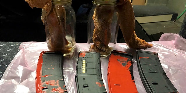 This photo posted Sunday, July 26, 2020, by the Portland Police Department on their Twitter page shows items the police say were loaded rifle magazines and Molotov cocktails found at a park in Portland, Oregon. (Portland Police Department via AP)