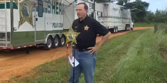 Polk Sheriff Grady Judd briefed reporters Saturday at the scene of a triple homicide on Lake Streety in Frostproof, Florida.