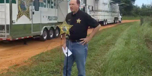 Polk Sheriff Grady Judd briefed reporters Saturday at the scene of a triple homicide on Lake Streety in Frostproof, Florida.