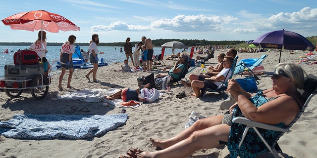 People gather on a beach on July 17, 2020 in Gotland, Sweden. (Martin von Krogh/Getty Images)