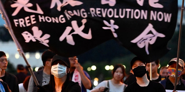A demonstrator waves a flag during a rally to show support for Hong Kong pro-democracy protests at Free Square in Taipei on June 13, 2020. 