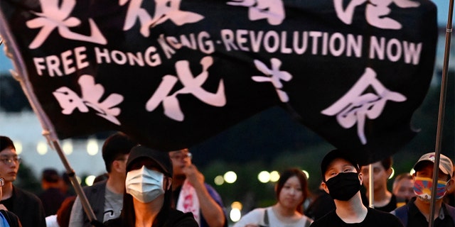 A demonstrator waves a flag during a rally to show support for Hong Kong pro-democracy protests at Free Square in Taipei on June 13, 2020. 