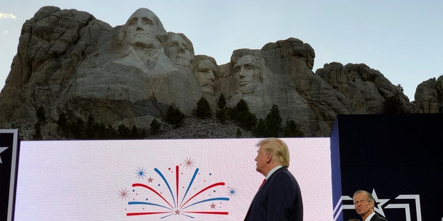 President Donald Trump stands on stage before he speaks at the Mount Rushmore National Monument Friday, July 3, 2020, in Keystone, S.D.