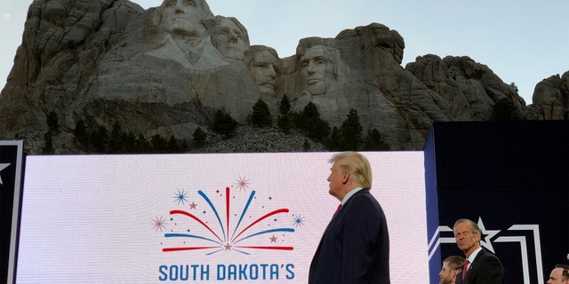 President Donald Trump stands on stage before he speaks at the Mount Rushmore National Monument Friday, July 3, 2020, in Keystone, S.D.