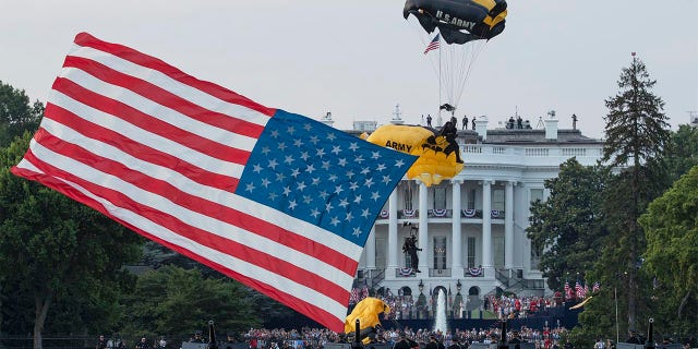 President Donald Trump and first lady Melania Trump watch as the U.S. Army Golden Knights Parachute Team descend during a "Salute to America" event on the South Lawn of the White House, Saturday, July 4, 2020, in Washington. (AP Photo/Alex Brandon)