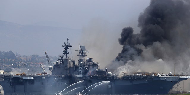 A fire burns on the amphibious assault ship USS Bonhomme Richard at Naval Station San Diego July 12, 2020 in San Diego.  (Photo by Sean M. Haffey / Getty Images)