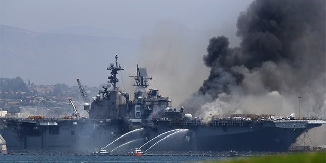 SAN DIEGO, CALIFORNIA - JULY 12: A fire burns on the amphibious assault ship USS Bonhomme Richard at Naval Base San Diego on July 12, 2020 in San Diego, California. There was an explosion on board the ship with multiple injuries reported. (Photo by Sean M. Haffey/Getty Images)