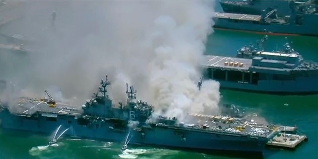 This screenshot provided by KGTV-TV in San Diego shows the USS Bonhomme Richard at Naval Base San Diego Sunday, July 12, 2020, in San Diego after an explosion and fire Sunday on board the ship at Naval Base San Diego. (KGTV-TV via AP)