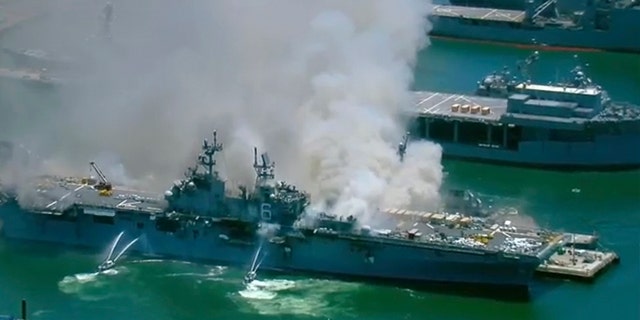 This screenshot provided by KGTV-TV in San Diego shows the USS Bonhomme Richard at Naval Base San Diego Sunday, July 12, 2020, in San Diego after an explosion and fire Sunday on board the ship at Naval Base San Diego. (KGTV-TV via AP)