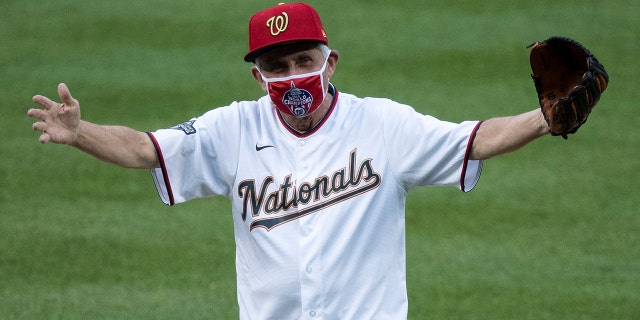 Dr. Anthony Fauci, director of the National Institute of Allergy and Infectious Diseases, reacts after throwing out a ceremonial first pitch before an opening day baseball game between the Washington Nationals and the New York Yankees at Nationals Park, Thursday, July 23, 2020, in Washington. (AP Photo/Alex Brandon)