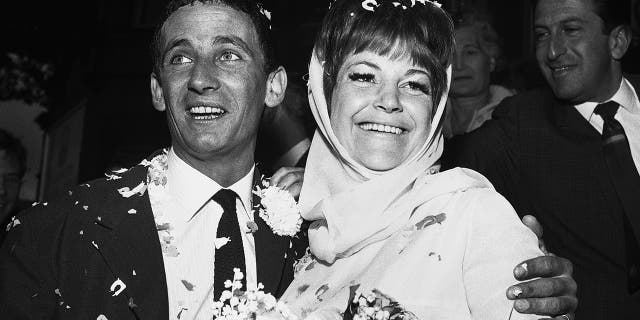 In this Aug. 19, 1963, file photo, British jazz singer Annie Ross, right, and actor Sean Lynch are covered with confetti after their marriage in London. Ross, who rose to fame as a jazz singer in the 1950s, struggled with personal problems in the '60s, faded from the spotlight in the '70s, re-emerged as a successful character actress in the '80s and finished her career as a cabaret mainstay, died on July 21 at her home in New York.
