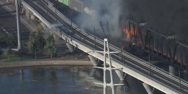 A train bridge partially collapsed after a derailment and fire in Tempe, Ariz. on July 29, 2020.