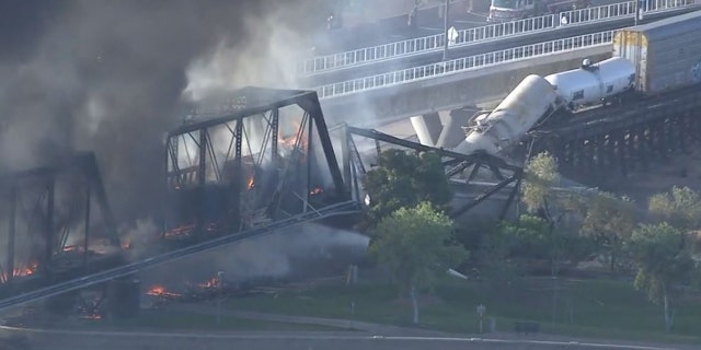 A train bridge partially collapsed after a derailment and fire in Tempe, Ariz. on July 29, 2020.