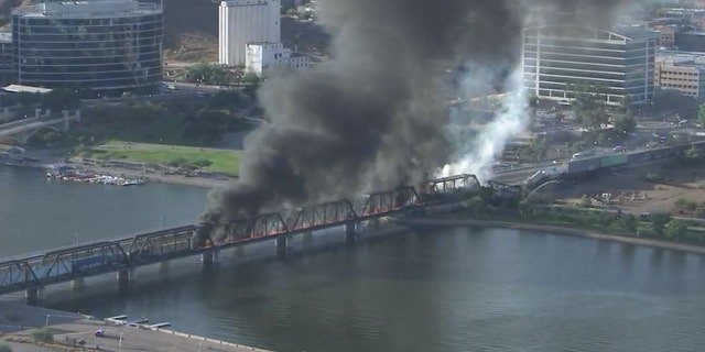 A train bridge partially collapsed after a derailment and fire in Tempe, Ariz. on July 29, 2020.