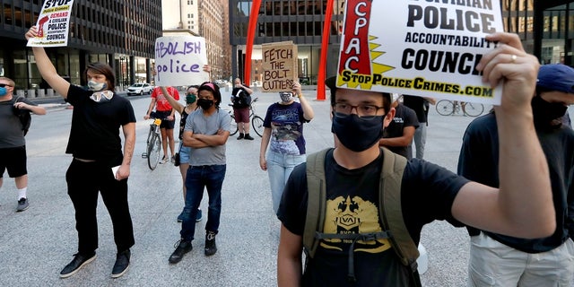 Protesters gather on Federal Plaza on Thursday after a collection of Chicago groups announced a federal lawsuit against the Chicago Police Department and others to prevent agents from making arrests or detaining people without probable cause. (AP Photo/Charles Rex Arbogast)