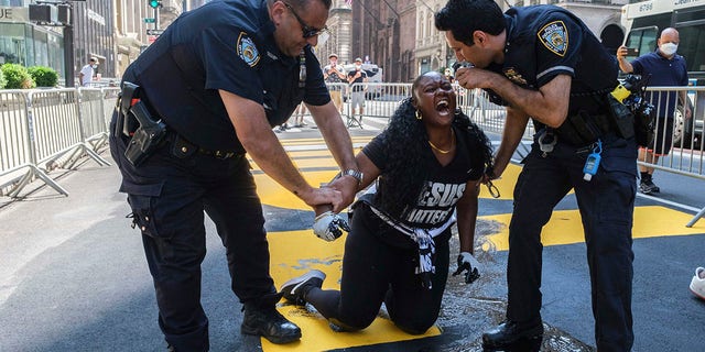 NYPD officer injured during arrest of women smearing paint on ...