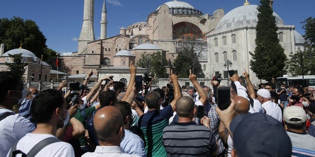 People chant slogans following Turkey's Council of State's decision, outside the Byzantine-era Hagia Sophia, one of Istanbul's main tourist attractions in the historic Sultanahmet district of Istanbul, Friday, July 10, 2020.