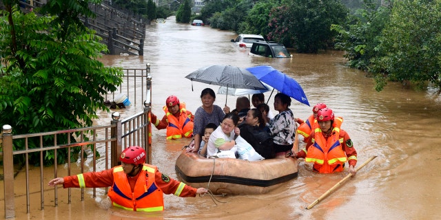Rescuers evacuate residents on a raft through flood waters in Jiujiang in central China's Jiangxi province July 8.