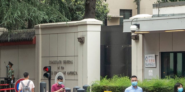 This photo taken on July 23, 2020 shows people walking past the entrance of the US consulate in Chengdu, southwest China's Sichuan province. China on July 24 ordered the closure of the U.S. consulate in the southwestern city of Chengdu, in retaliation for America shuttering Beijing's diplomatic mission in Houston this week.  (Photo by STR/AFP via Getty Images)