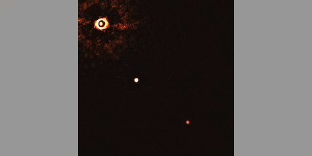 This image, captured by the SPHERE instrument on ESO’s Very Large Telescope, shows the star TYC 8998-760-1 accompanied by two giant exoplanets. (Credit: ESO/Bohn et al.)