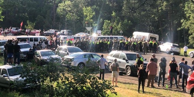 Sheriff's deputies and National Guard troops confront protesters near Mount Rushmore, S.D.