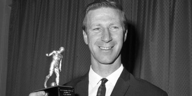 Jack Charlton holds his award after being elected Footballer of the Year by the Football Writers' Association at the Association's annual dinner at the Cafe Royal, London, May 18, 1967. (Associated Press)