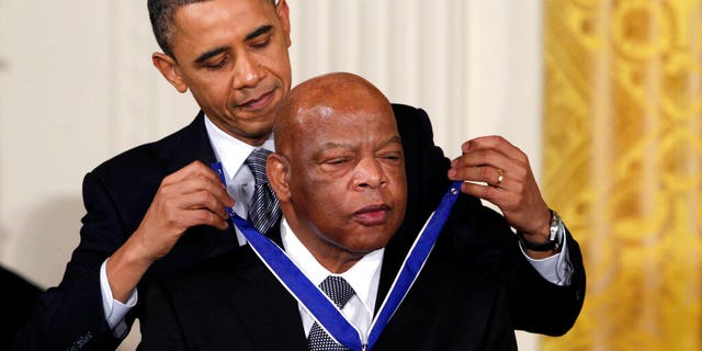 FILE - In this Feb. 15, 2011, file photo, President Barack Obama presents a 2010 Presidential Medal of Freedom to U.S. Rep. John Lewis, D-Ga., during a ceremony in the East Room of the White House in Washington. Lewis, who carried the struggle against racial discrimination from Southern battlegrounds of the 1960s to the halls of Congress, died Friday, July 17, 2020. (AP Photo/Carolyn Kaster, File)