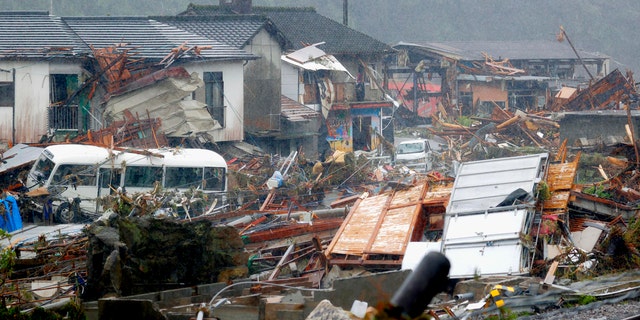 Debris is scattered at a residential area hit by heavy rain in Kumamura, Kumamoto prefecture, southern Japan Tuesday, July 7, 2020.