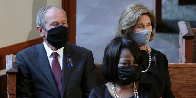 Former President George W. Bush and his wife Laura Bush are seated for the funeral service for the late Rep. John Lewis, D-Ga., at Ebenezer Baptist Church in Atlanta, Thursday, July 30, 2020. (Alyssa Pointer/Atlanta Journal-Constitution via AP, Pool)