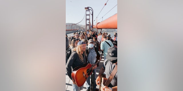 Sean Feucht, Hold The Line founder, leads worship at the Golden Gate Bridge on Thursday, July 9, 2020. Between 300 and 400 gathered to protest the state's ban on singing in churches due to a surge in coronavirus cases, organizers said.