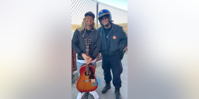 Sean Feucht, Hold The Line founder, pictured with law enforcement as his group protested the state's ban on singing in churches. Feucht said they prayed over every police officer present.