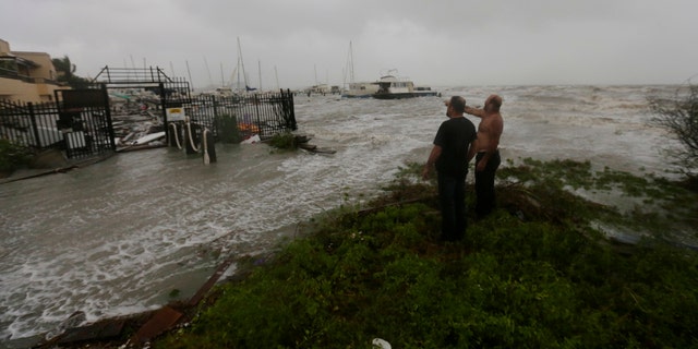 Boat owners examine the damage after the docks at the marina where their boats had been secured were destroyed as Hurricane Hanna made landfall, Saturday, July 25, 2020, in Corpus Christi, Texas.
