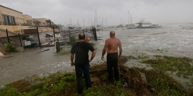 Boat owners examine the damage after the docks at the marina where their boats had been secured were destroyed as Hurricane Hanna made landfall, Saturday, July 25, 2020, in Corpus Christi, Texas.