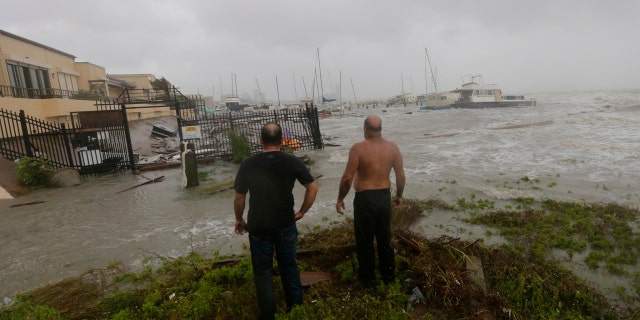 Boat owners examine the damage after the docks at the marina where their boats had been secured were destroyed as Hurricane Hanna made landfall, Saturday, July 25, 2020, in Corpus Christi, Texas.