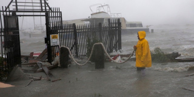 Jame Rowles examines the damage after the docks at the marina where his boat was secured were destroyed as Hurricane Hanna made landfall, Saturday, July 25, 2020, in Corpus Christi, Texas.