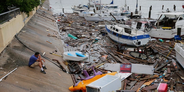Allen Heath surveys the damage to a private marina after it was hit by Hurricane Hanna, Sunday, July 26, 2020, in Corpus Christi, Texas.