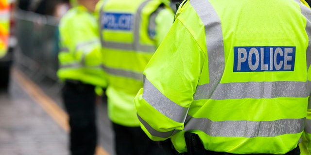 Stock photo shows British police wearing visible jackets. 