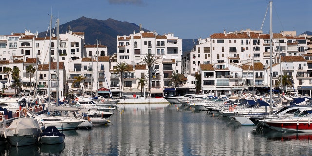 Two men have died in Spain after a British tourist fell from a balcony at a hotel and landed on another man below, according to officials.
