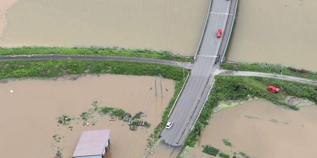 A residential area is flooded following a heavy rain in Oishida town, Yamagata prefecture, northern Japan Wednesday, July 29, 2020.