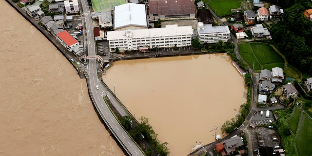 A schoolyard of a junior high school is seen flooded following heavy rains in Gero, Gifu prefecture, central Japan Wednesday, July 8, 2020.