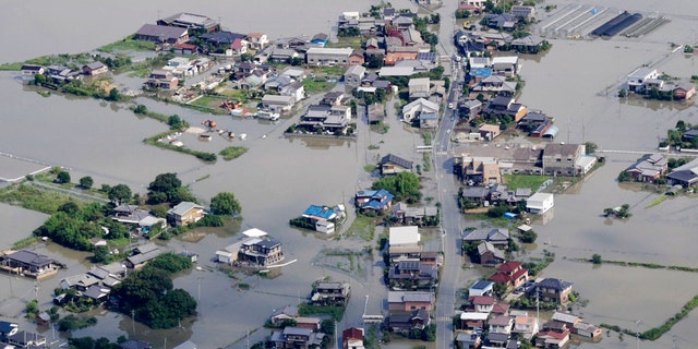 This aerial photo shows the flooded area caused by the swollen Chikugo River, not seen in photo, in Kurume city, Fukuoka prefecture, southern Japan Wednesday, July 8, 2020.