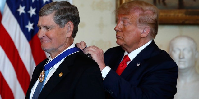 President Donald Trump presents the Presidential Medal of Freedom to Jim Ryun, in the Blue Room of the White House, Friday, July 24, 2020, in Washington. (AP Photo/Alex Brandon)