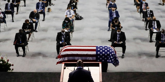 Rev. Darryl Caldwell speaks as the casket of the late Rep. John Lewis, D-Ga., lies in repose during a service celebrating "The Boy from Troy" at Troy University on Saturday, July 25, 2020, in Troy, Ala. Lewis, who carried the struggle against racial discrimination from Southern battlegrounds of the 1960s to the halls of Congress, died Friday, July 17, 2020. (AP Photo/Brynn Anderson)