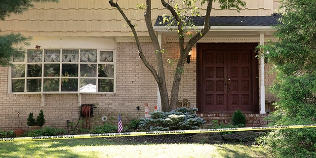 Crime scene tape surrounds the home of U.S. District Judge Esther Salas, July 20, in North Brunswick, N.J. A gunman posing as a delivery person shot and killed Salas' 20-year-old son and wounded her husband Sunday evening at their New Jersey home before fleeing, according to judiciary officials. (AP Photo/Mark Lennihan)