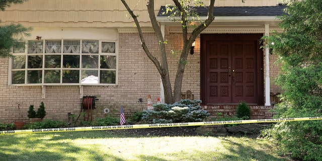 Crime scene tape surrounds the home of U.S. District Judge Esther Salas, July 20, in North Brunswick, N.J. A gunman posing as a delivery person shot and killed Salas' 20-year-old son and wounded her husband Sunday evening at their New Jersey home before fleeing, according to judiciary officials. (AP Photo/Mark Lennihan)