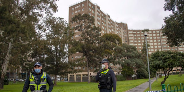 Police guard access to apartments under lockdown in Melbourne, Australia, on Monday. (AP)