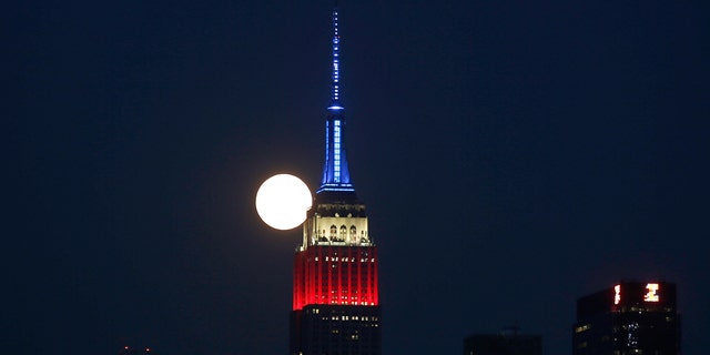 The full buck moon rises behind the Empire State Building on July 4, 2020 as seen from Weehawken, New Jersey. (Photo by Gary Hershorn/FOX News)